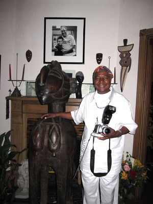 Poet Eugene Redmond with a Nimba statue from the Baga people of Guinea.