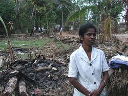 Mrs. C. Vinita of Belliwate village not only lost her home in the tsunami, but also her daughter, who was getting ready to write her A-level exam. She stands in front of property flattened by the tsunami. 