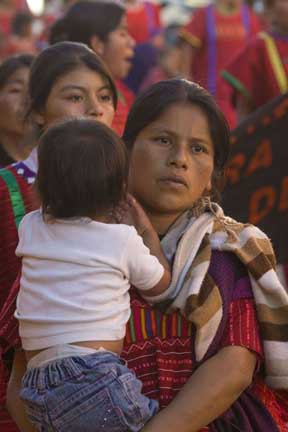 The march called on the governor, Gabino Cue, to guarantee their safety when they try to return to the town and to arrest those responsible for the killings.