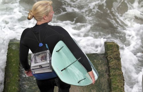 Photo by Shmuel Thaler of the Santa Cruz Sentinel of Vice Mayor Hilary Bryant delivering books to surfers