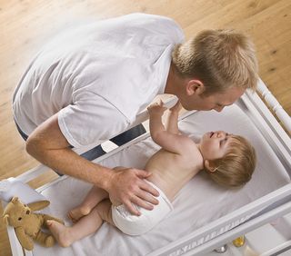 Bigstock-A-young-father-is-changing-his-27200900