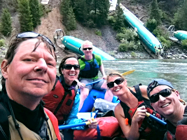 Missoula whitewater rafter Daniel Berger (at rear) and friends float past three airliner fuselages dumped in Montana's Clark Fork river by a train derailment last week. Photo courtesy Chuck Irestone