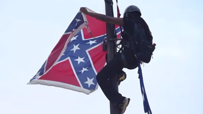 Bree Newsome scaling the flagpole