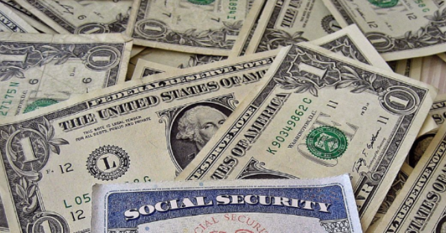 Social security card on a bed of money