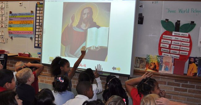 Children in a first-grade class in Wichita, KS field questions from their teacher in a lesson about the origins of Christianity as part of a unit on three world religions: Judaism, Christianity, and Islam.