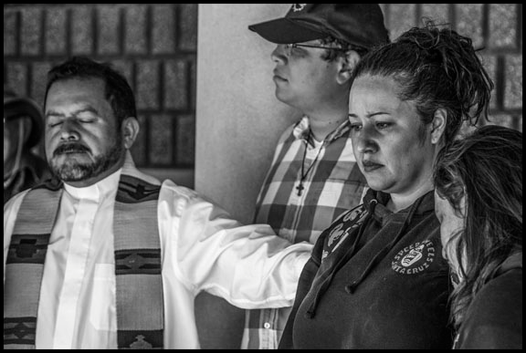 Rev. Pablo Morataya comforts Lourdes Barraza