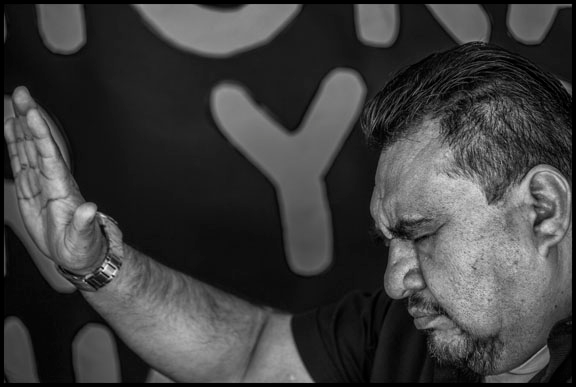 A vigil participant shows support for the people inside