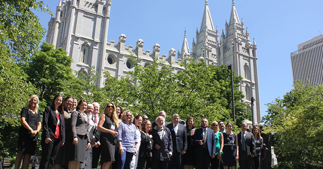 Presenters, including author Linda K. Wertheimer, from the Brigham Young University’s Religious Freedom Annual Review conference and hosts from the Mormon church stand in front of the Salt Lake Temple.
