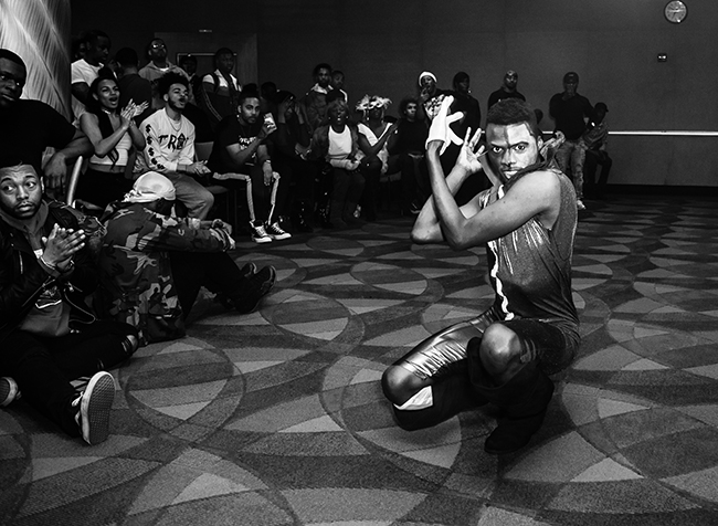 At the 2019 “Escape from Arkham” Kiki ball in the Bronx, NY, Two-Face vogues and slays the competition. © Kareem Worrell.