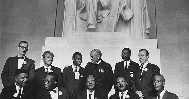 Leaders of the March on Washington in front of the statue of Abraham Lincoln: (sitting L-R) Whitney Young, Cleveland Robinson, A. Philip Randolph, Martin Luther King Jr., and Roy Wilkins; (standing L-R) Mathew Ahmann, Joachim Prinz, John Lewis, Eugene Carson Blake, Floyd McKissick, and Walter Reuther.