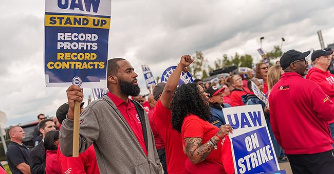 President Joe Biden walks along the UAW picket line and engages with union members at the GM Willow Run Distribution Center, Tuesday, September 26, 2023, in Belleville, Michigan.