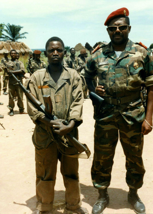 H - A soldier with a visiting general at Cangando garrison  near Malanje  after a battle with UNITA. copy