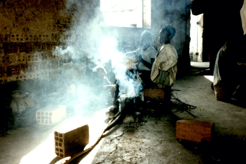 N- Family cooks in ruined building  Kuito